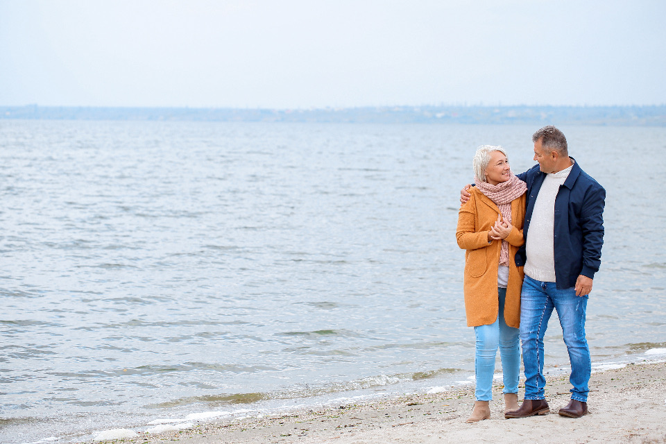 A couple standing together at the edge of the water
